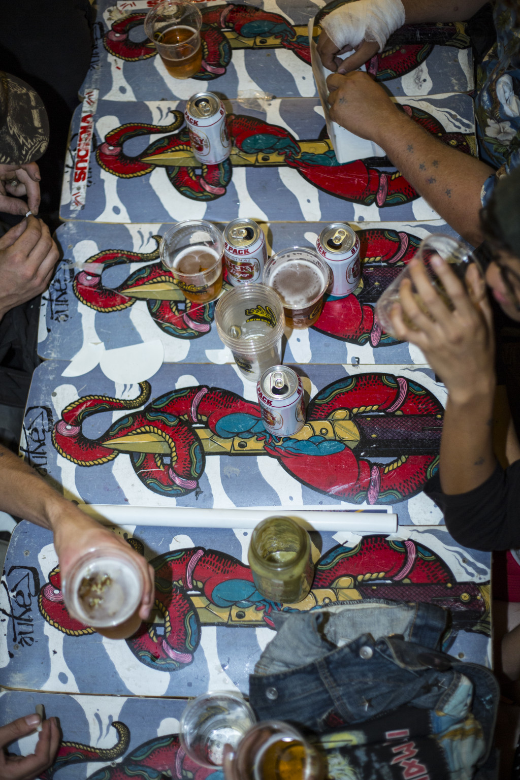 Someone left their smoothy jar on the table. A table thats MADE OF LONGBOARDS!